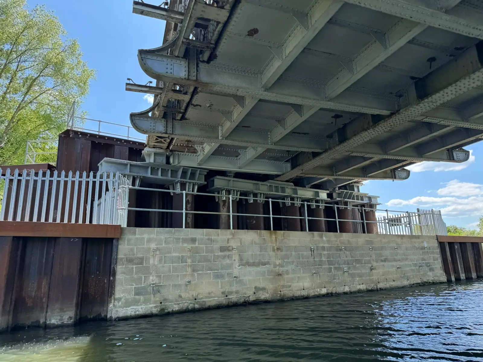 Bridge soffit and abutment wall seen from the water