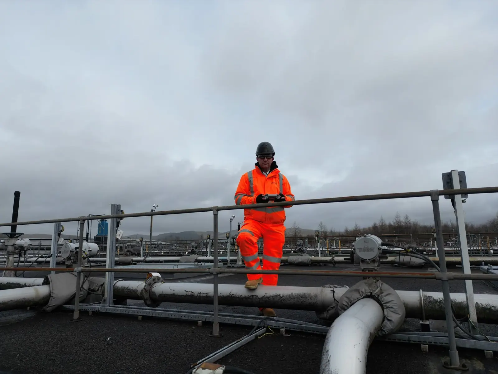 Drone pilot flying from an industrial walkway