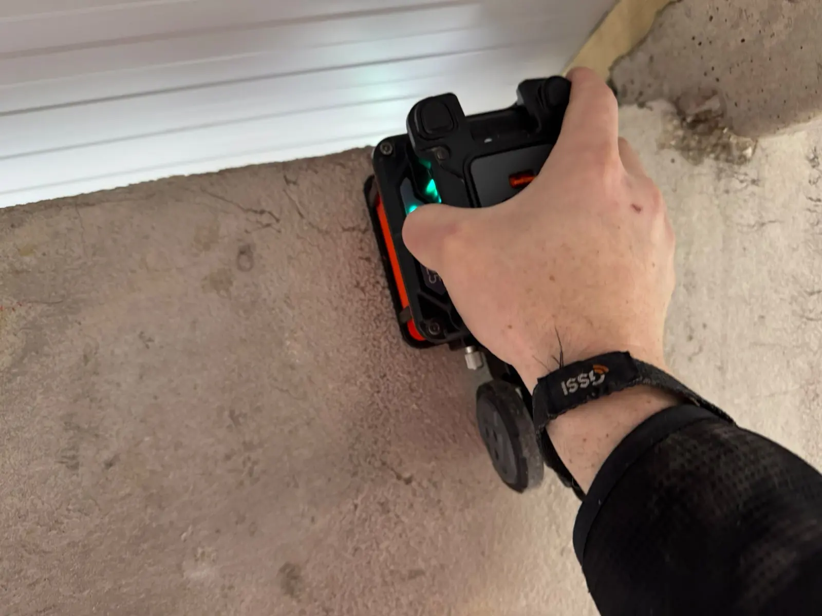 Handheld ground penetrating radar unit on a concrete wall