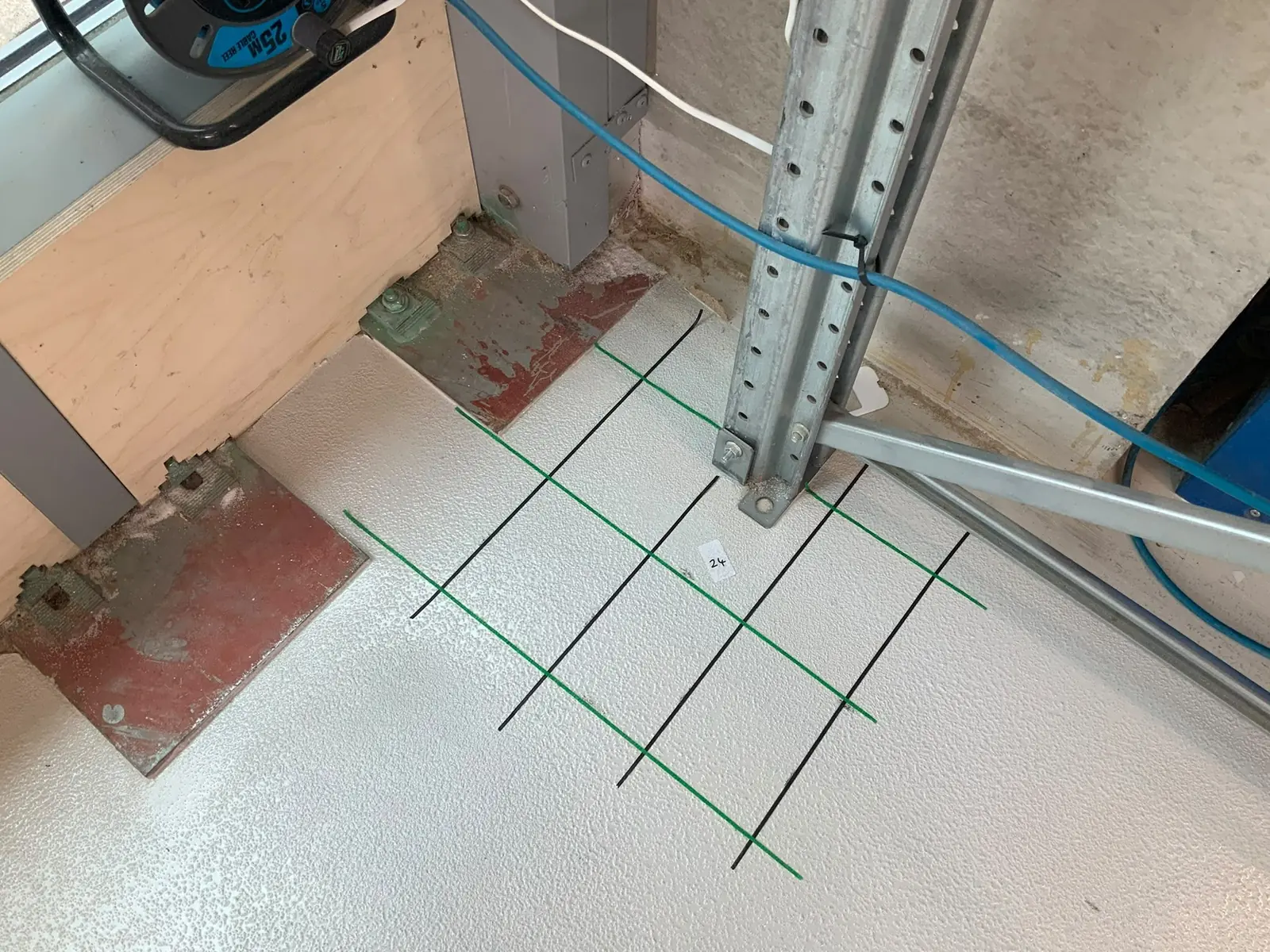 Survey grid marked out on a large concrete floor